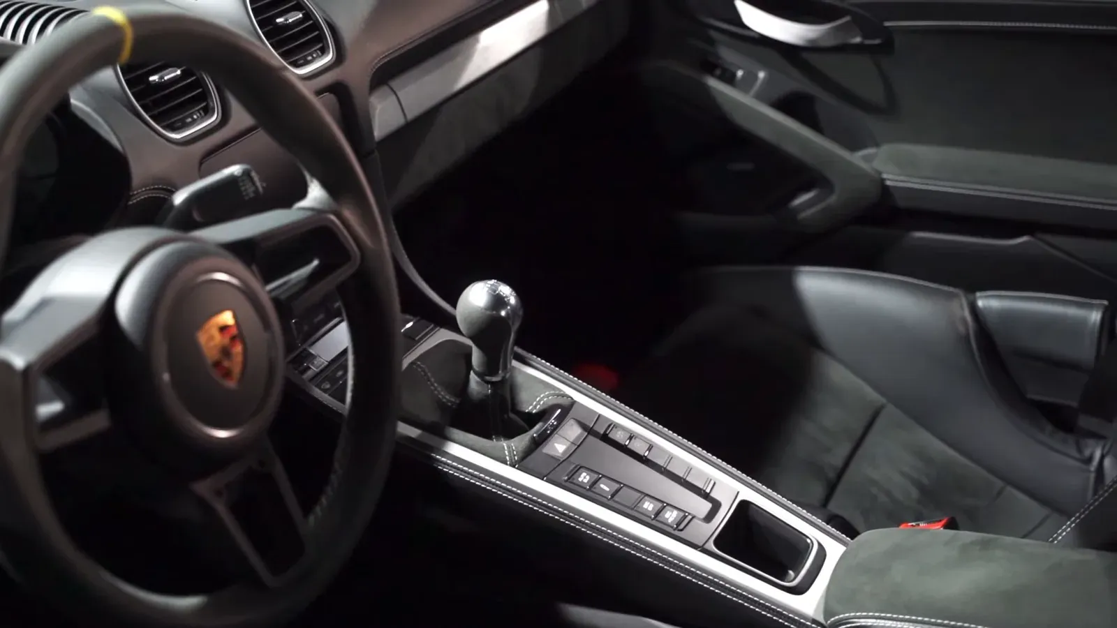 The cabin of David Middleton’s Porsche 718 GT4, showing the steering wheel and the manual gear lever