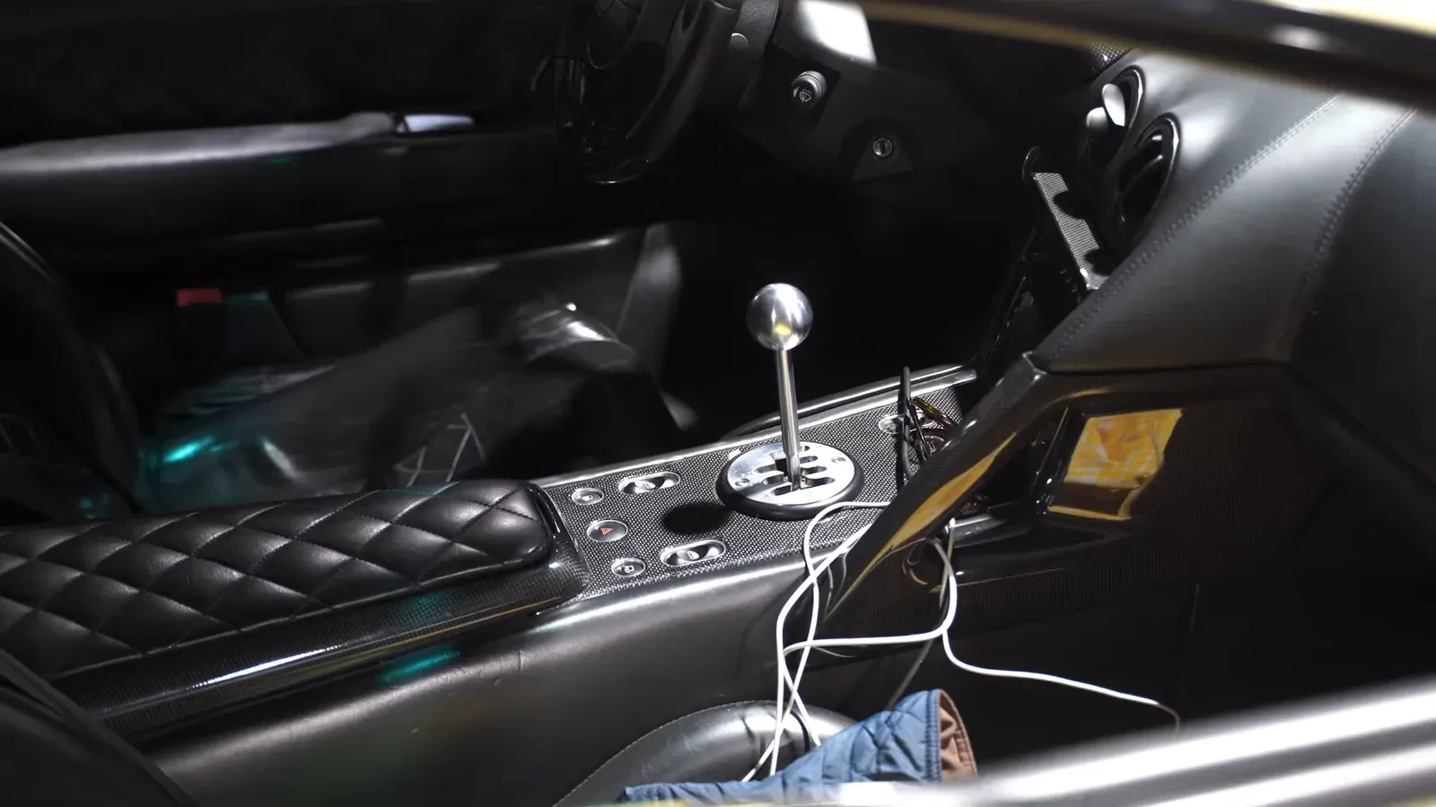 The gated manual shifter and diamond-stitched console inside Ed Bolian’s green Lamborghini Murciélago LP640