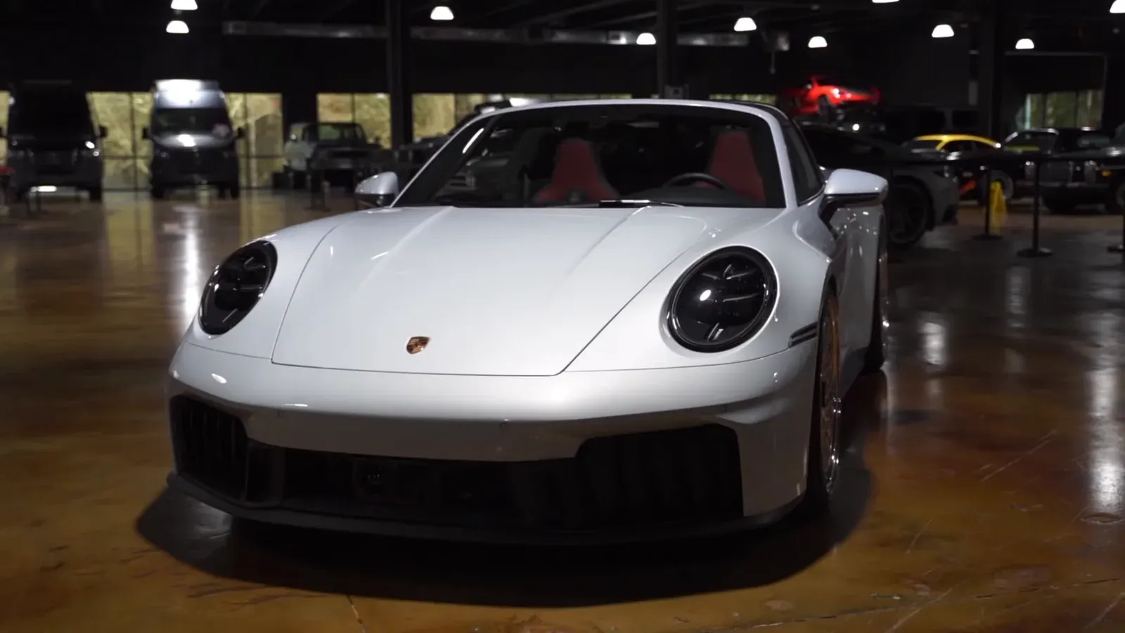 Emran Alborno’s white 2026 Porsche 911 Targa 4 GTS with red seats, seen head-on on the lounge floor