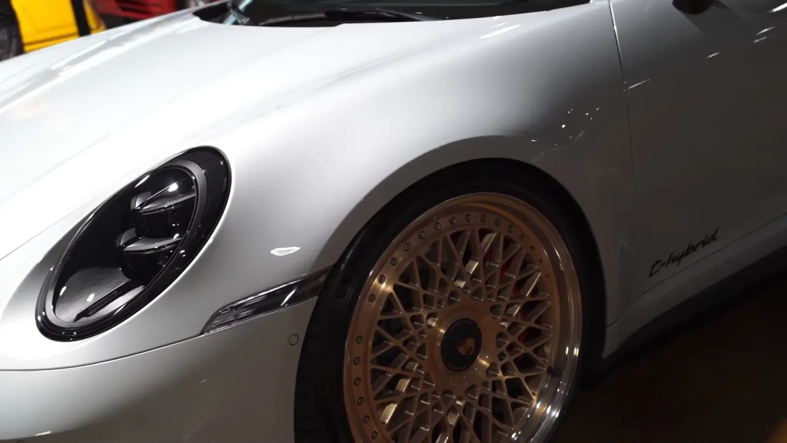 Front corner of Emran Alborno’s white Porsche 911 Targa 4 GTS with a gold mesh three-piece wheel