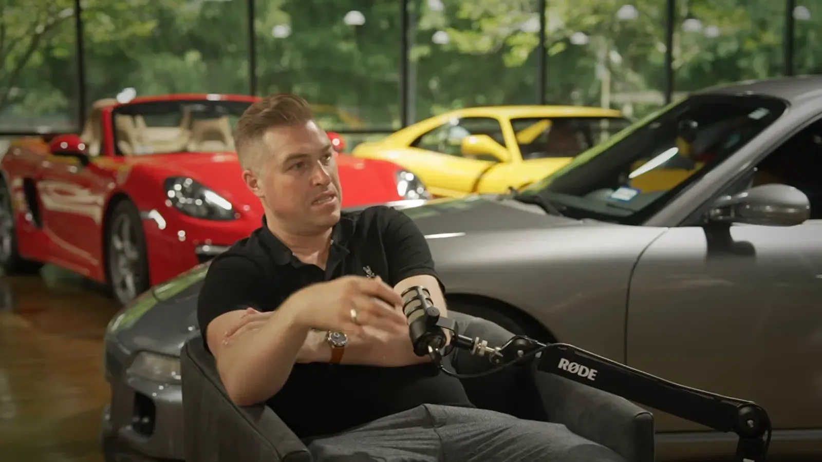 Marat Pashkevich talking on the Throttlecast set at The Ride Lounge, cars on the floor behind