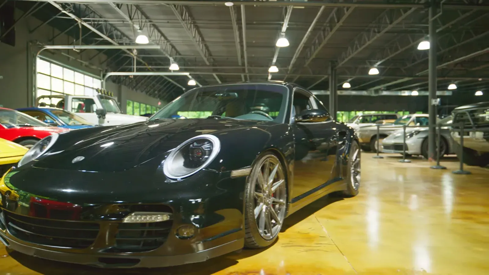 Matt Lamarsh’s black 2007 Porsche 911 Turbo parked on the lounge floor, front three-quarter view