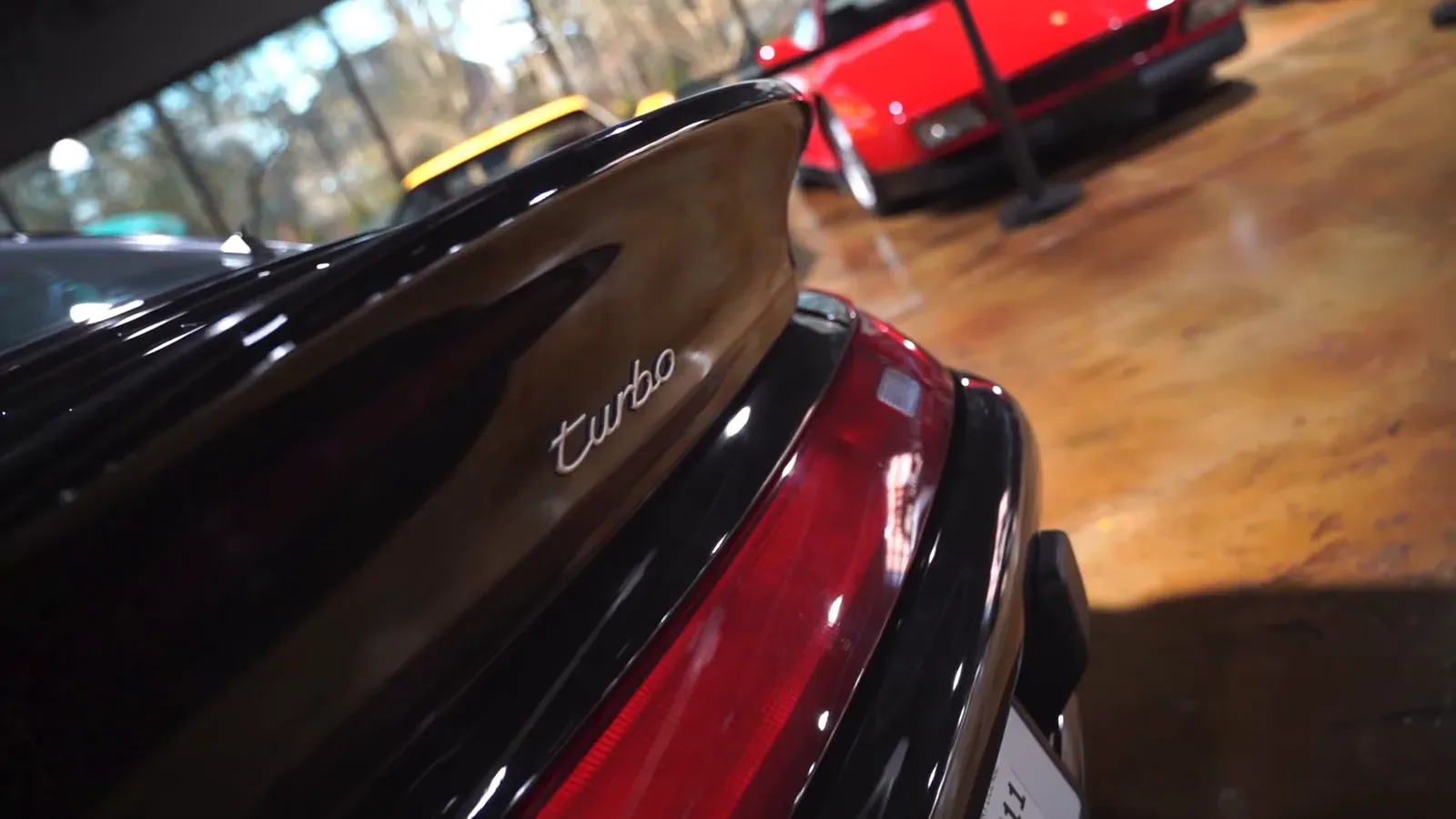 Close-up of the turbo script on the rear wing of the black Porsche 993