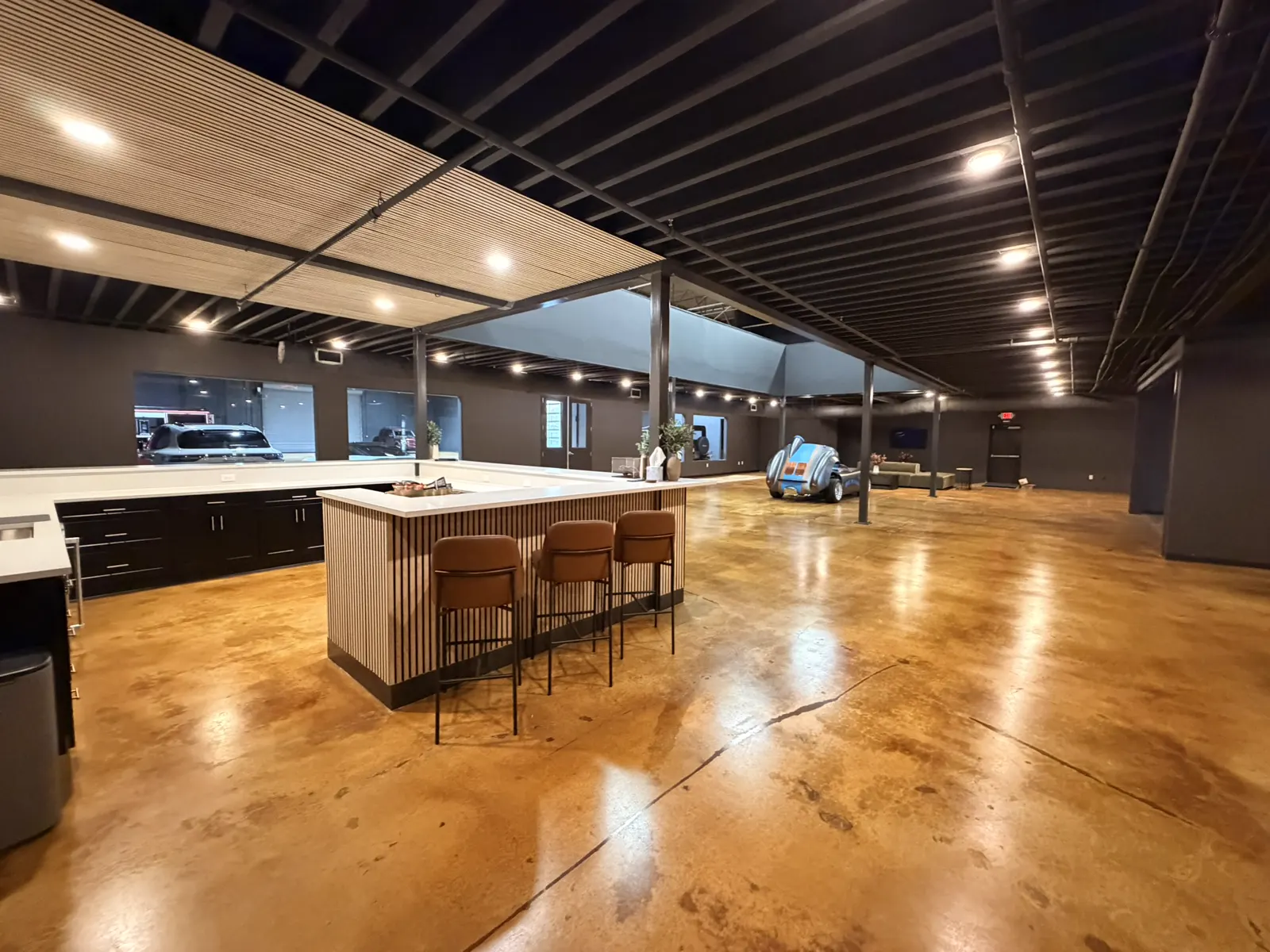 The Atlanta bar island and stools, with the lounge and cars beyond